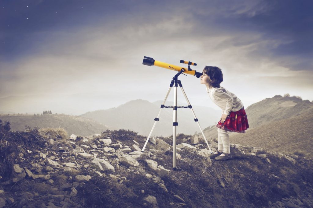 Girl looking through telescope