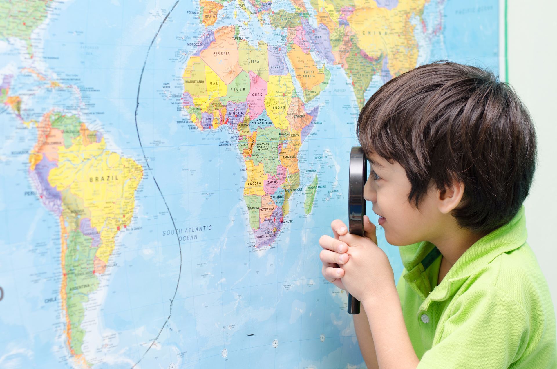 Boy looking at world map with magnifying glass Edublogs
