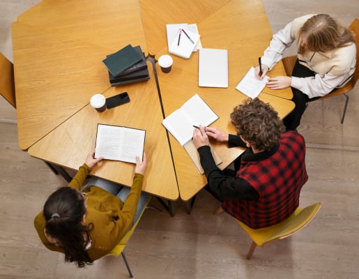 Three students working at a hexagon shaped desk